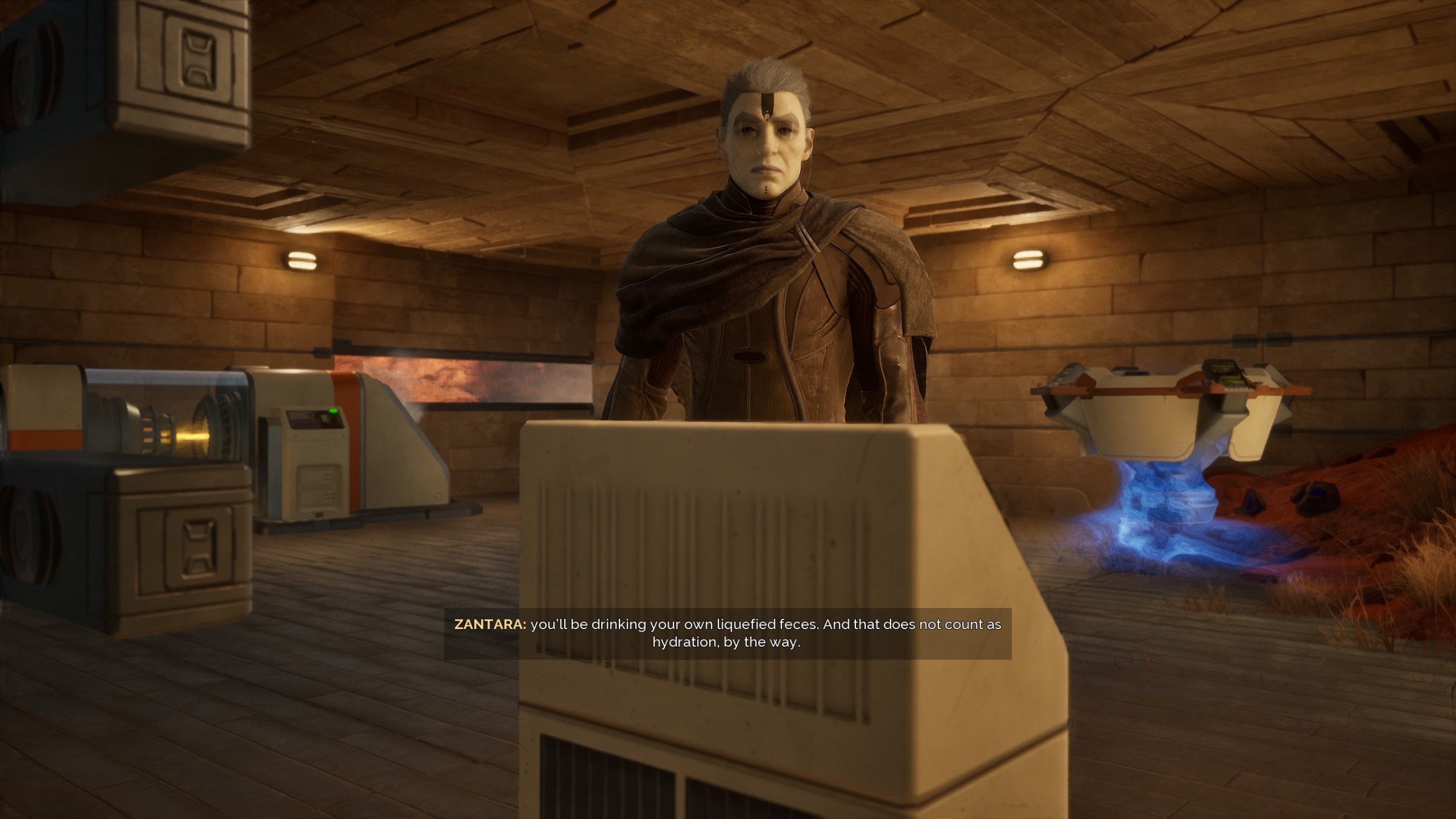 Zantara, Dune Awakening’s guide, telling the player: “You’;ll be drinking your own liquified feces. And that does not count as hydration, by the way”